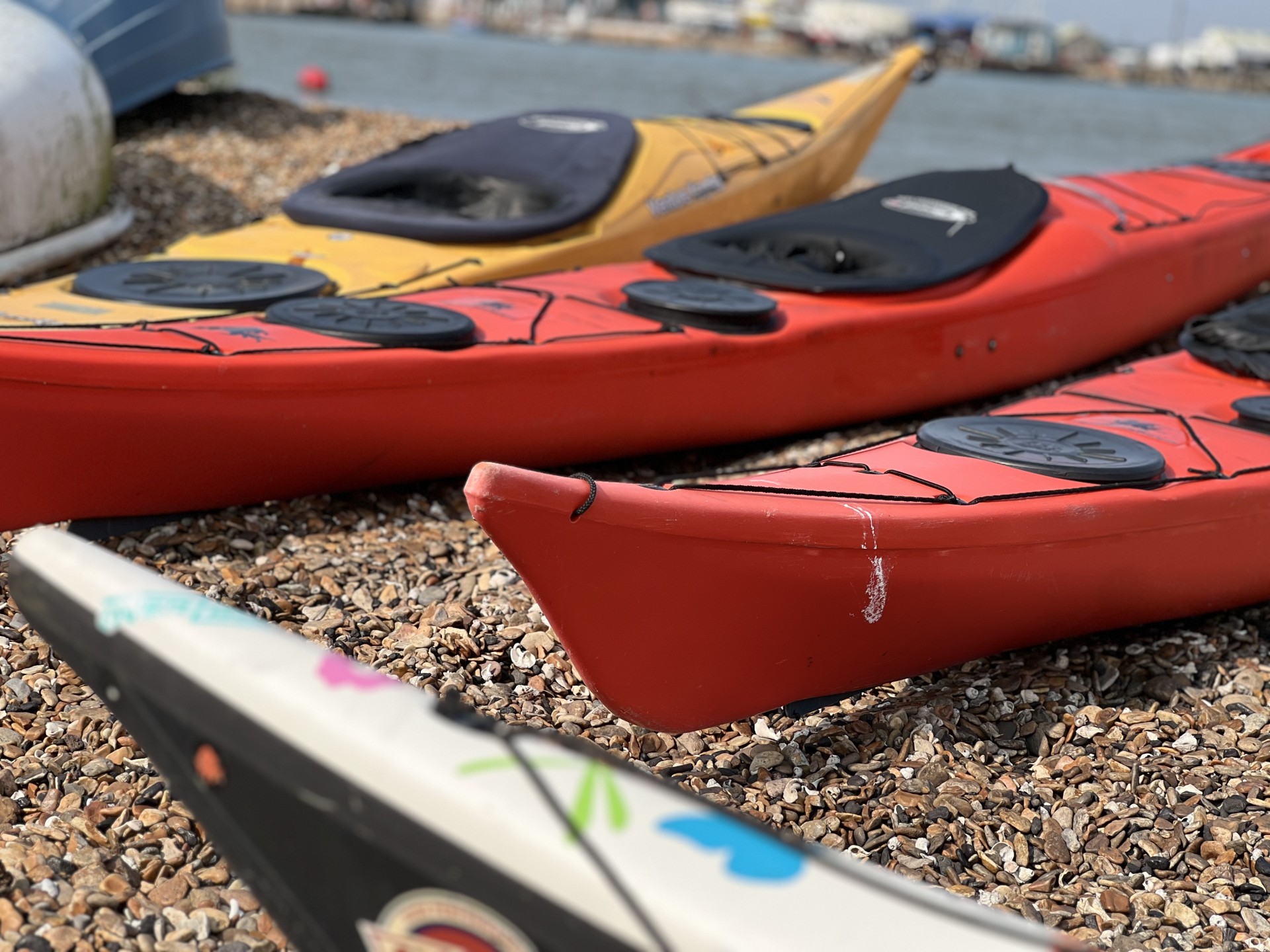 Sea kayaks on the beach with NOMAD Sea Kayaking in Suffolk, UK.