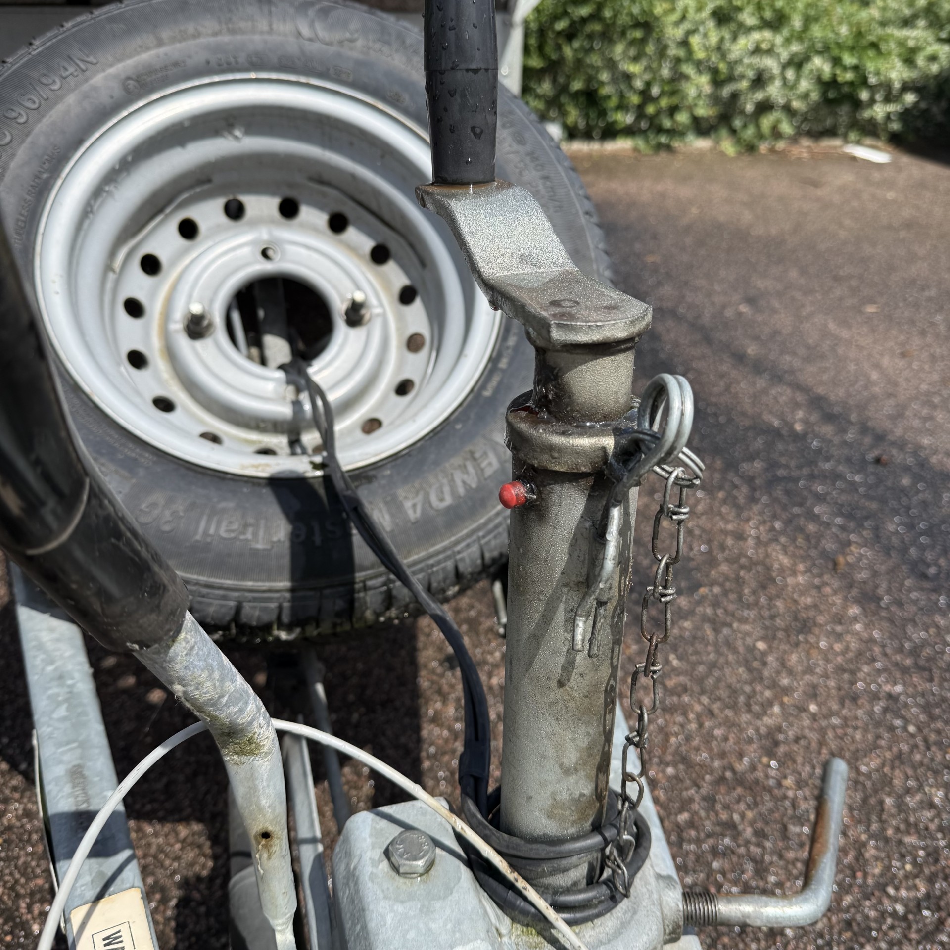 Slanted spare wheel for rain water run off Motiv braked kayak canoe trailer.
